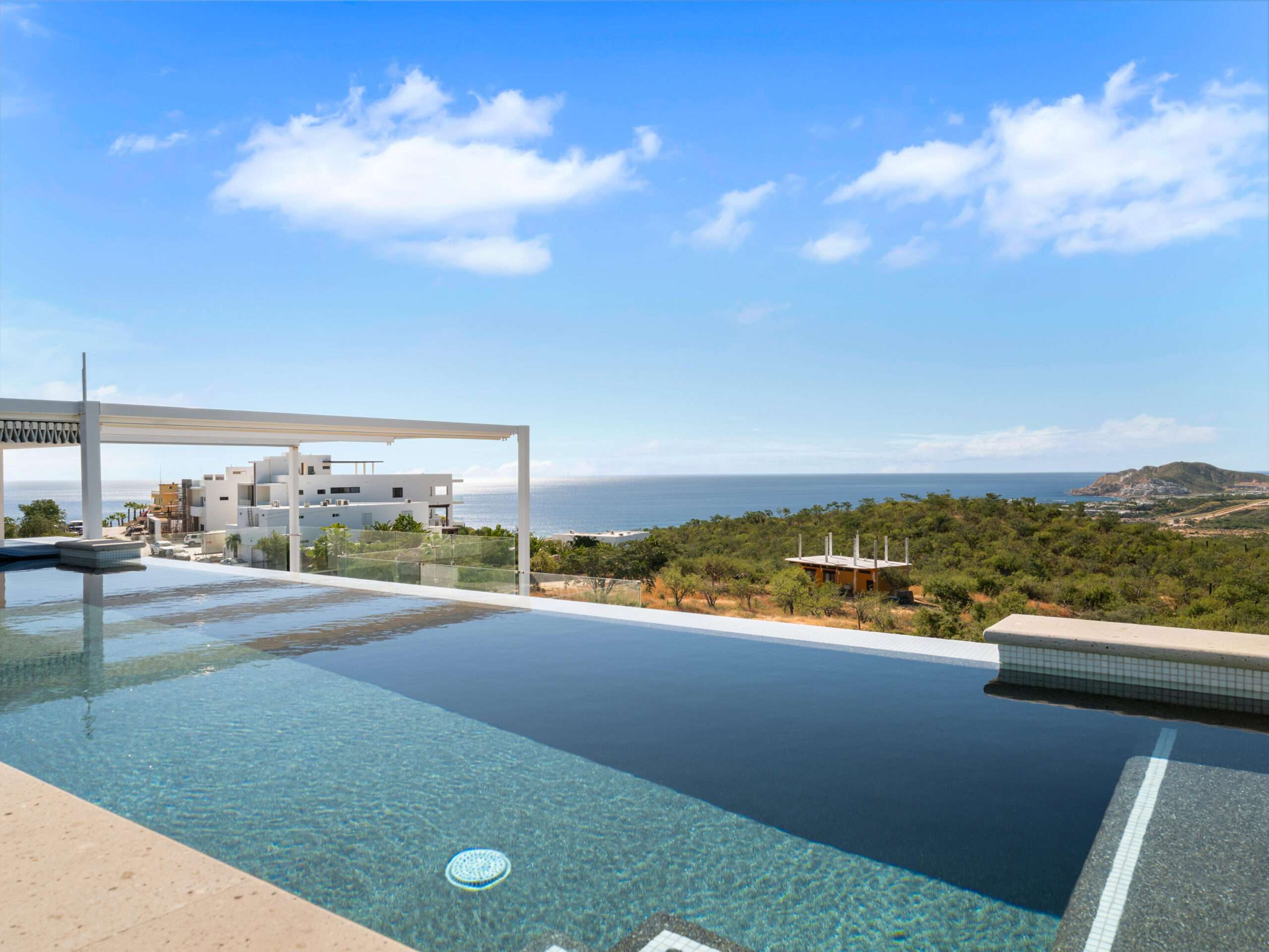 Cabo Luxury Section 4- Las Canadas Discover refined indoor-outdoor living at Cañada 9, set within Querencia, San Jose del Cabo's premier private golf community. Soaring beamed ceilings, walls of pocket glass, and luminous marble floors define an open great room that flows effortlessly to the terrace, infinity-edge pool, and stone-clad water feature -- all framed by panoramic Sea of Cortez and mountain for sale